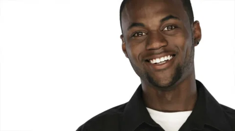 Black man smiles into the camera on a white background Stock Footage 33842093