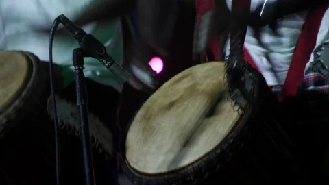 Black man standing with plaster on finger playing djembe with drum rings Stock-Footage 208940481