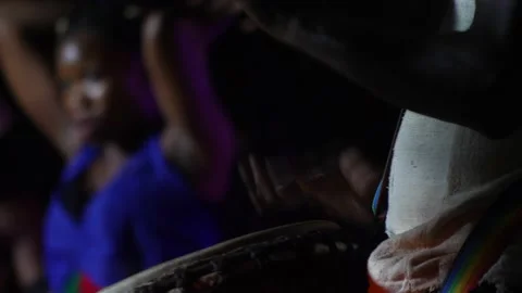 Black man standing with plaster on finger playing djembe 스톡 동영상 208940513