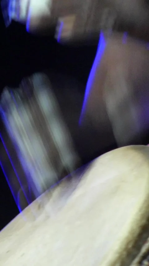 Black man standing with plaster on finger playing djembe Stock Footage 230691189