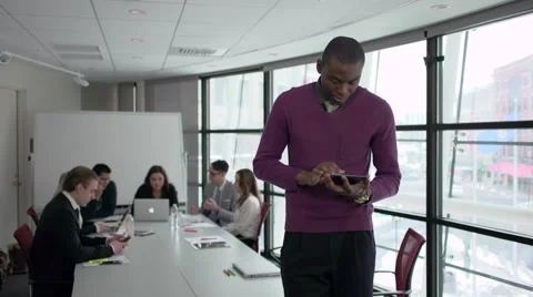 A Black Man Stands Infront of Professionals in a Meeting (2 of 4) Stock Footage 47628443