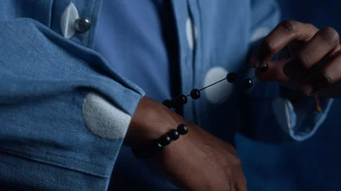 Black Man Stretching Elastic Beaded Bracelet on His Wrist Stock Footage 341387500