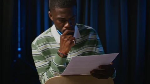Black Man Studying Script in Student Theater Rehearsal Stock Footage 344528341