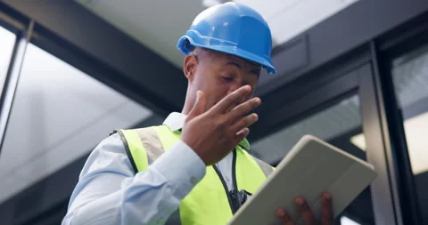 Black man, tablet and engineer in office with stress, notes or low angle for Stock Footage 335832074