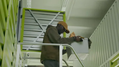 Black Man Taking Box out of Self Storage Unit Stock Footage 290778941