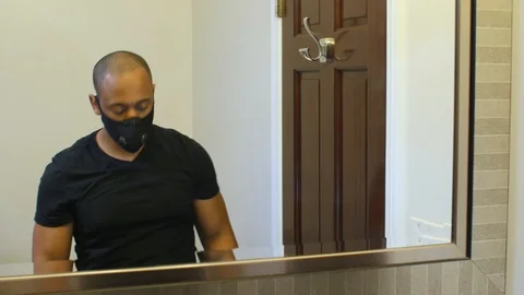 Black man taking off gloves and face mask Stock Footage 126746460