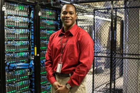 Black man technician in a computer server farm. 스톡 사진