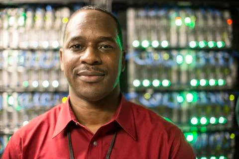 Black man technician in a computer server farm. 스톡 사진