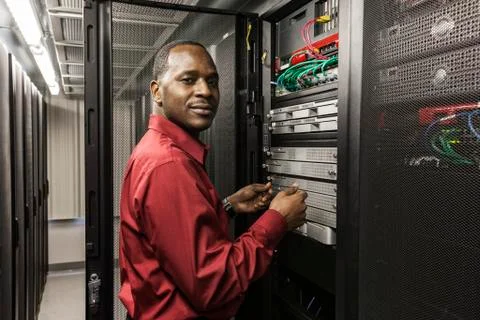 Black man technician working on computer servers in server farm. 스톡 사진