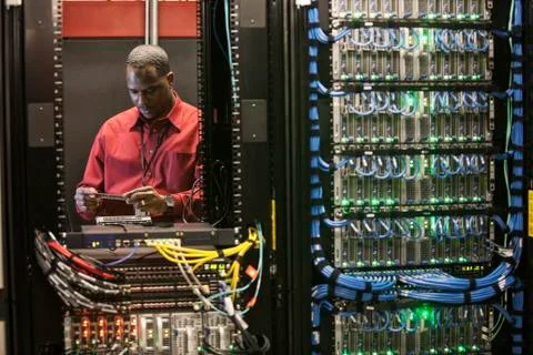 Black man technician working on computer servers in server farm. 스톡 사진