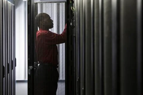 Black man technician working on computer servers in server farm. 스톡 사진