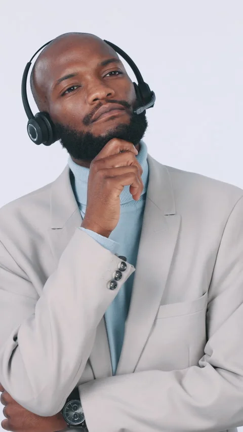 Black man, thinking or consultant with headset in studio for enquiry on a white Stock Footage 331568611