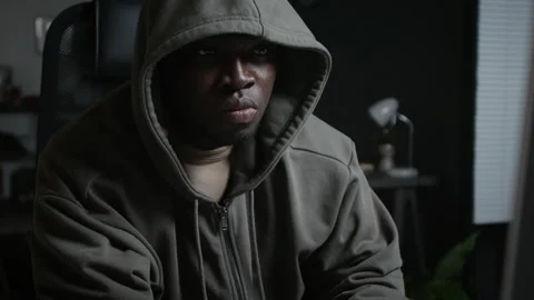 Black Man Typing on Computer Keyboard in Dark Room at Night Stock Footage 348152907