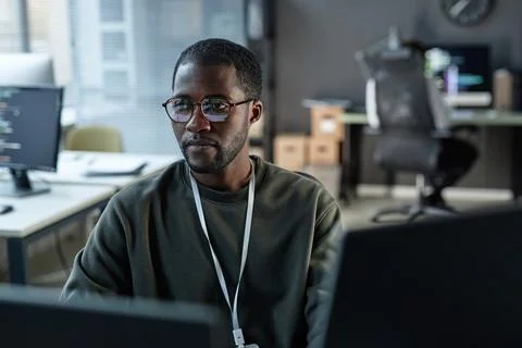 Black Man Using Computer in IT Development Office Stock Photos