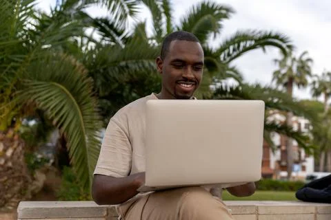 Black man using netbook in park Stock Photos