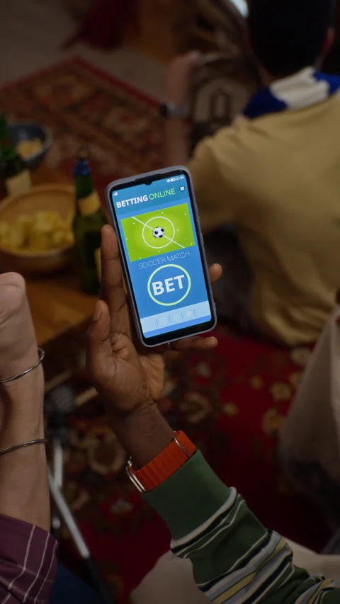 Black Man Using Online Sports Betting App on Smartphone Stock Footage 344658384