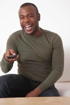 Black man using remote control Stock Photos