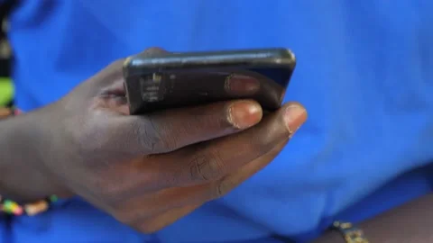 Black man using smartphone: african man hand holding a mobile phone Stock Footage 217822003