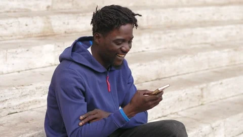 Black man using smartphone: african man hand holding a mobile phone 스톡 동영상 218602239
