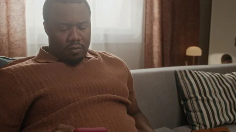 Black Man Using Smartphone While Tossing Baseball during Break Stock Footage 337720544