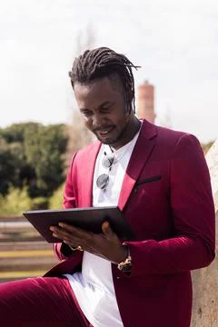 Black man using a tablet outdoors in the city Stock Photos