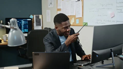 Black Man Using Walkie Talkie in Cybersecurity Office Stock Footage 346814161