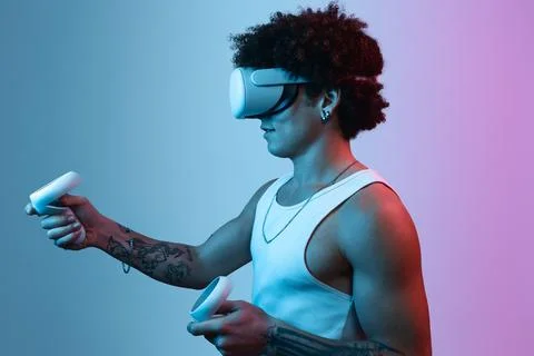 Black man in VR headset using controllers Stock Photos