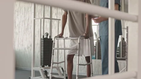 Black Man with Walkers at Physiotherapy Session Stock Footage 194413101