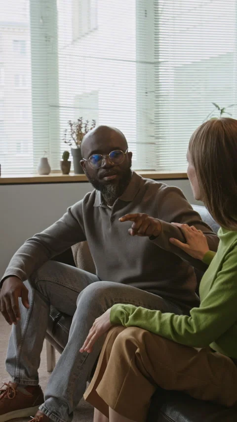 Black Man Walking Away from Crying Woman during Therapy Session Stock Footage 337641632