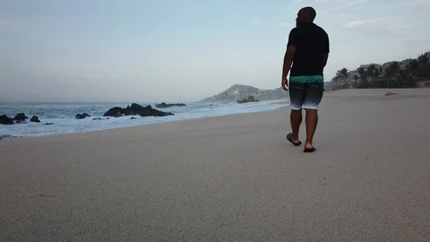 Black man walking on beach. Stock Footage 113939768