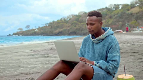 Black man work computer laptop. African american freelancer type macbook at sea. 스톡 동영상 246407434