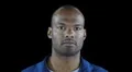 Black man in workers jumpsuit - distracted and then ducks out of way Video HD