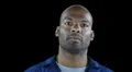 Black man in workers jumpsuit - pop in and surprised smile HD動画