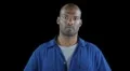 Black man in workers jumpsuit - serious attentive look Video HD