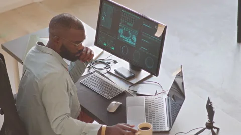 Black Man Working on New Software Program in Office Stock Footage 224031979