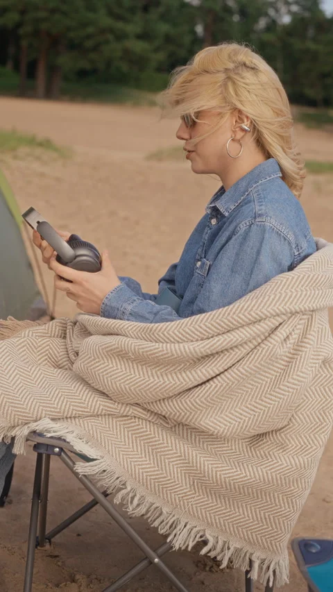 Black Man Working Remotely on Laptop in Tent Handing Headphones to Woman Stock Footage 343248115