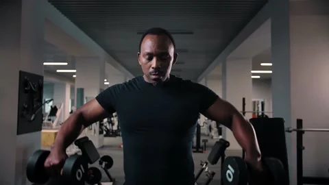 Black man workout with dumbbell training shoulders in gym.Bodybuilder training Stock Footage 225714554