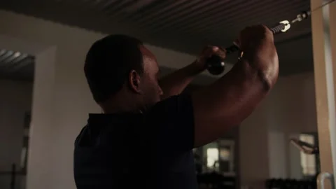 Black Man workout in the gym doing shoulder exercise in crossover.Bodybuilder Stock Footage 225715188