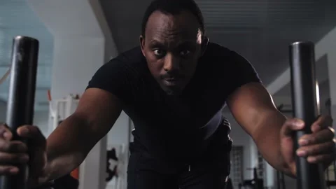 Black man workout pushes a heavy weight trolley in the gym in slow motion Stock Footage 225714729