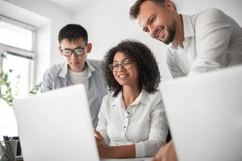 Black manager explaining project to colleagues Stock Photos