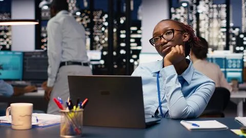 Black manager thinking about new ideas while reviewing notes on laptop Stock Photos