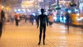 The black mannequin standing in a people stream in an evening street. time lapse 4k or 4k+ Resolution