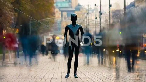 The black mannequin standing on the street with people Stock Photos
