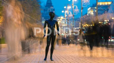 The black mannequin standing on the street with people Stock Photos