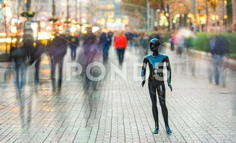 The black mannequin stands on the street among the stream of people Stock Photos