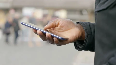 Black man's hand  scrolling the keypad on his mobile phone Video stock 131978685