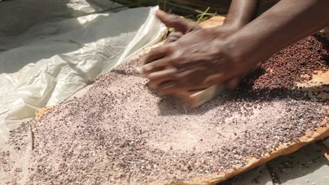 Black man's hands grinds stone into small pieces, manual stone grinding. Stock Footage 209891938
