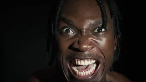 Black Mans Intense Expression in Dramatic Lighting Stock Footage 298169782