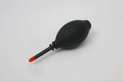 Black manual blower for cleaning the camera lens on a white background Stock Photos