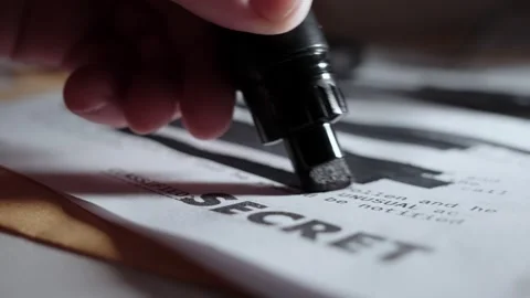Black marker drawing black lines on top secret paper before being declassified Vídeo Stock 199977149